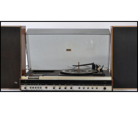 A 20th century Ferguson retro Studio 6 BSR record player in a teak finish with acryllic hood being complete with a good pair 