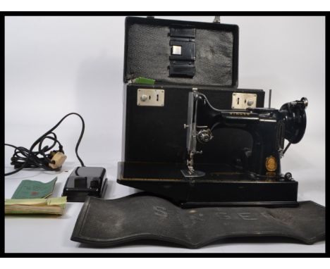 A 20th century vintage Singer Featherlite 221K sewing machine complete in the original carry case with accessories / manual e