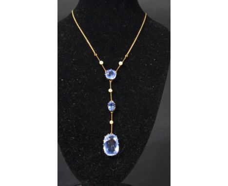 An early 20th century 18ct gold violet blue sapphire and seed pearl necklace having three faceted violet blue sapphires with 