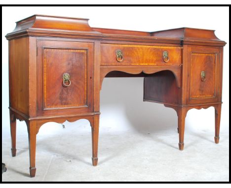 A Georgian 19th century mahogany drop centre pedestal sideboard being raised on square tapering legs comprising end lockers, 