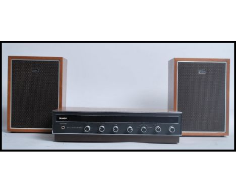 A 1970's Sharp Hi-Fi stereo system with black facia and turn dials together with the associated speakers. Measures 29.5cms h 