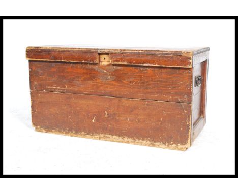 A 19th century Victorian workmans pine blanket box / tool chest with hinged cover having iron drop handles to the fielded pan