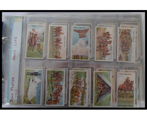 An album of vintage cigarette cards including Players Army Life , Wills military motors and many others.