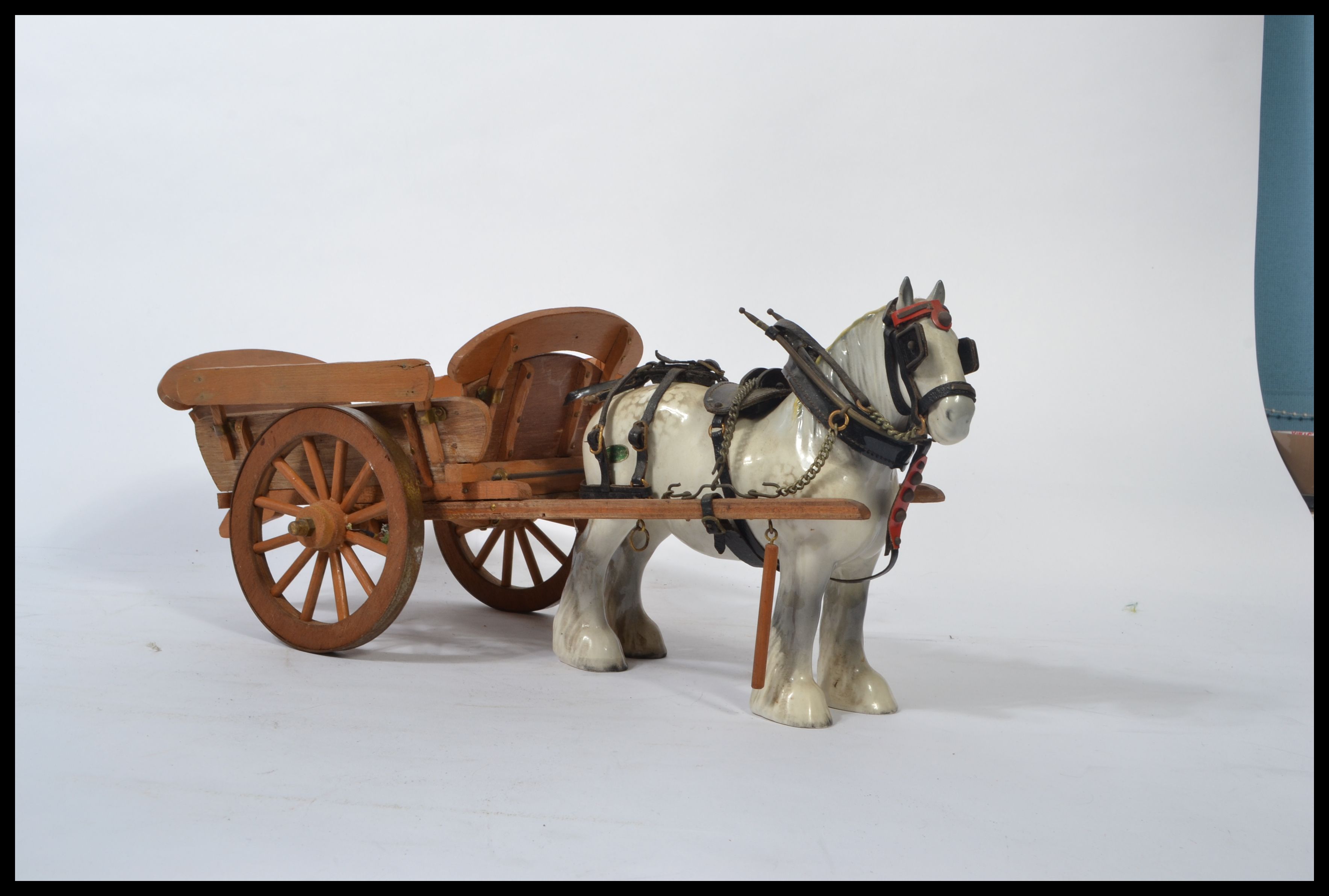 A Beswick ceramic figurine of a shire horse and cart in a white and