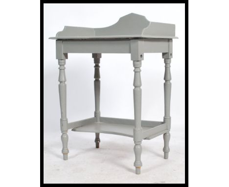 A 20th century antique style painted shabby chic console table. Raised on turned supports with gallery edge table top and low