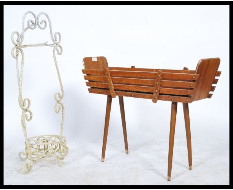A retro mid century wrought metal painted stick stand having twisted metal design and swivel base together with a retro mid c