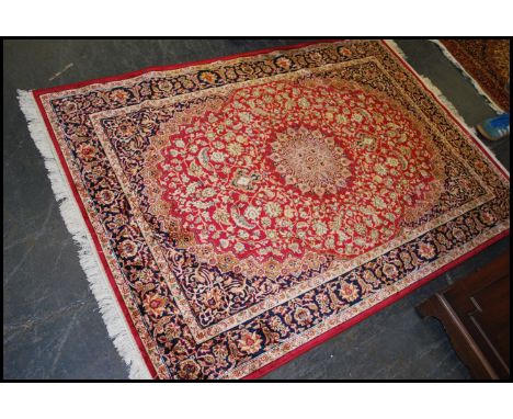 A large Iranian / Persian Keshan carpet - rug having red ground with geometric decoration and borders. Measures 1.90m x 1.40m