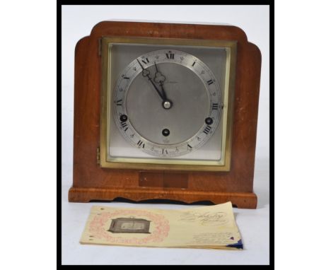 An mahogany cased eight day lever Elliot mantel clock having silvered dial with Roman numerals, eight day movement with Westm