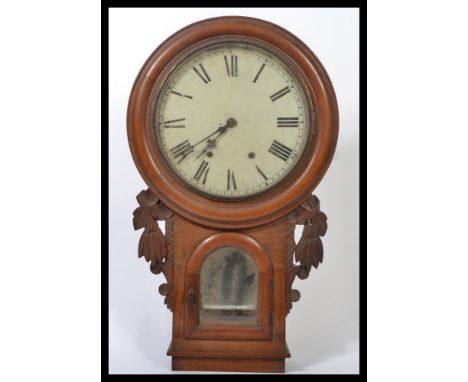 A 19th century Victorian wall mounted drop dial school clock having a mahogany case with carved side embellishments. The circ