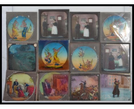 A vintage wooden magic lantern slide case full with vintage magic lantern slides, including mostly hand coloured slides of nu