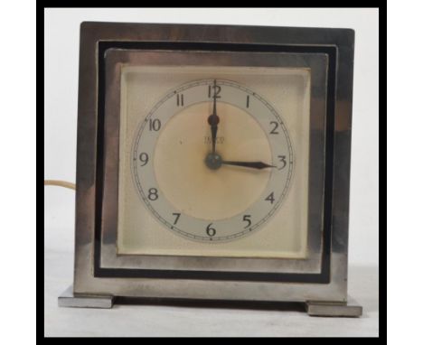 A 1930's Art Deco chrome and bakelite mantel clock by Temco. The decorative face with bakelite covered movement having chrome