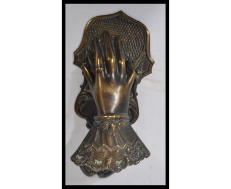 A 19th century Victorian figural brass novelty letter or paperclip, the whole realistically modeled as an elegant ladies hand