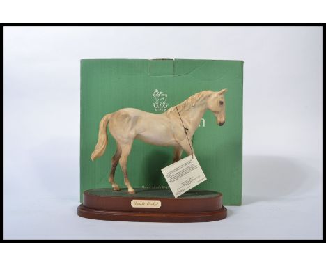 A Royal Doulton horse `Desert Orchid` style two, model No. DA184, light grey matt, 19.7cm high on wood plinth. Complete in bo