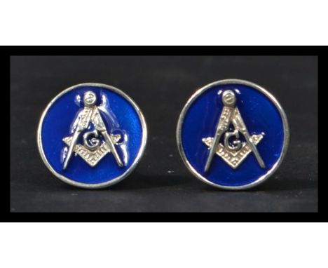 A pair of sterling silver cuff-links having blue enamel backs with masonic interest symbols.