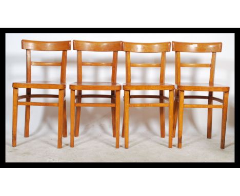 A retro mid century tubular metal and yellow formica kitchenette dining table together with a set of 4 mid century beech wood