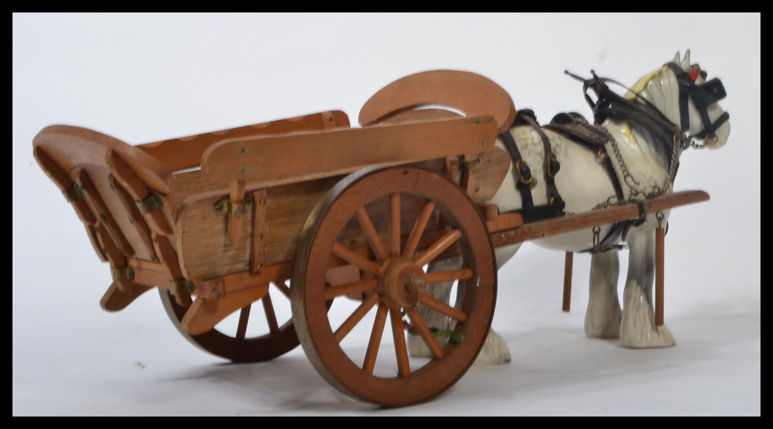 A Beswick ceramic figurine of a shire horse and cart in a white and