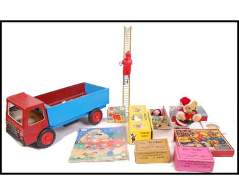 A collection of vintage 20th century children's toys comprising of; large wooden truck, children's books, Pelham Puppet JC Mo