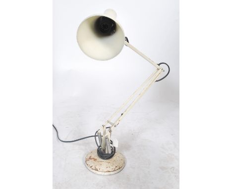 A vintage 20th century Herbert Terry anglepoise desk lamp being raised on circular base with a pendant shade in white colourw