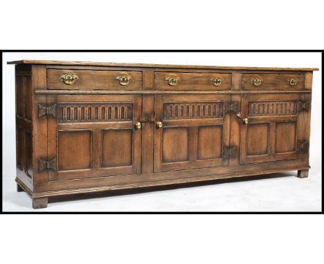 An exceptional Ipswich oak Jacobean revival dresser base sideboard having carved doors cupboards with short drawers above and