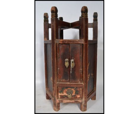 A late Qing dynasty Chinese hexagonal worktop washstand having a drawer to bottom and twin door cupboard revealing storage sp