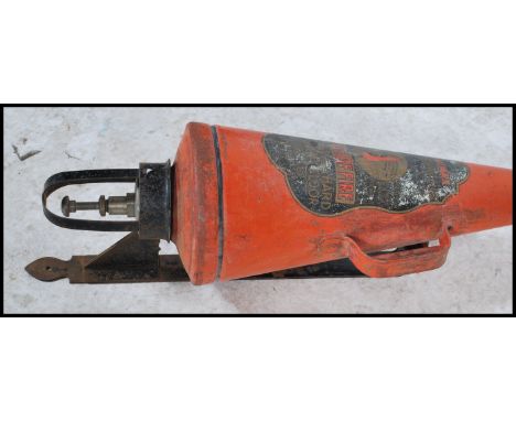 An early 20th Century Simplex type cone shaped fire extinguisher in red with handle and spout, and label to the front. Comple