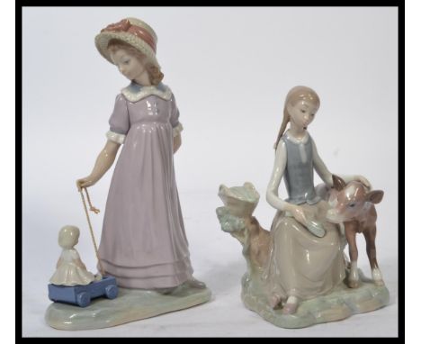 Lladro - A Lladro figurine entitled "Girl with Calf" # 01004813, marked to the base "Lladro hand made in Spain" approximately