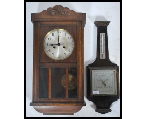 A vintage 20th century oak cased wall clock together with a oak aneroid barometer&nbsp;