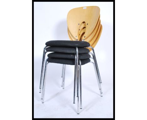 A set of four 20th century retro style stacking dining chairs, panel back with fabric seats raised on splayed chrome supports