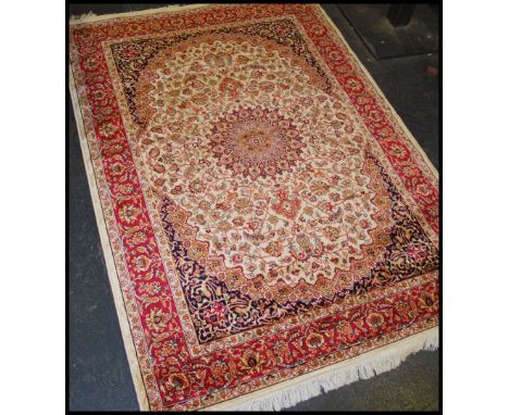 A large Iranian / Persian Keshan carpet - rug having beige ground with geometric decoration and borders. Measures 1.90m x 1.4