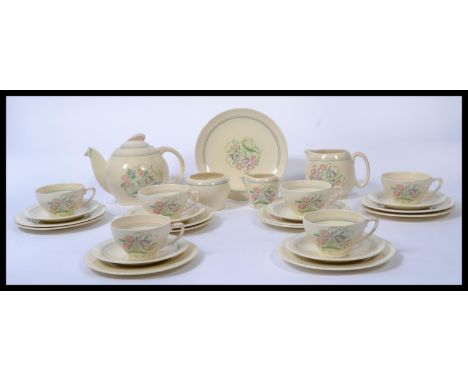 A vintage 20th century Susie Cooper Dresden Spray tea service in cream consisting of a teapot , large milk jug , small milk j