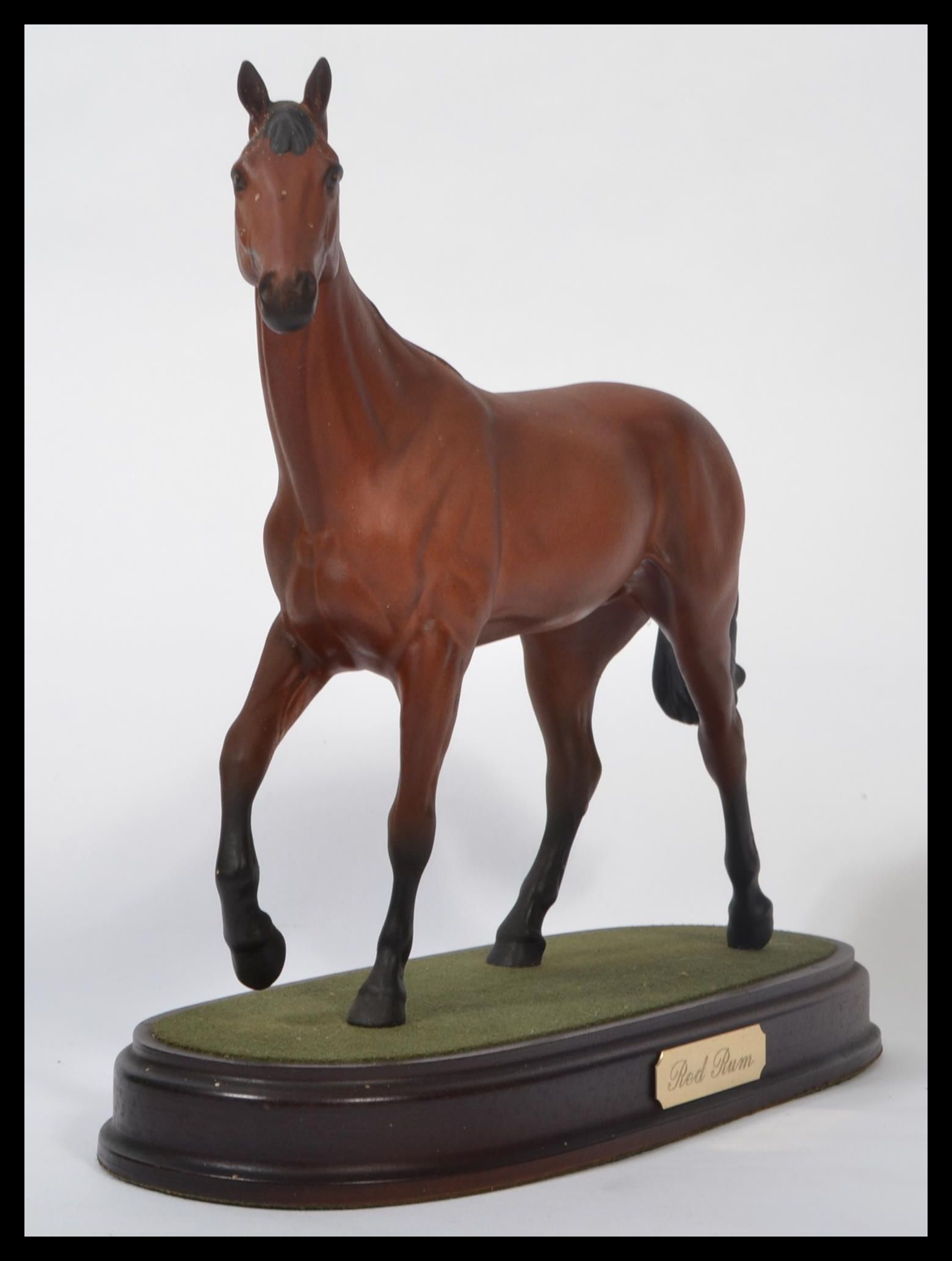 A Royal Doulton figurine of a race horse 'Red Rum', model No. DA18 on wooden plinth base. Measure