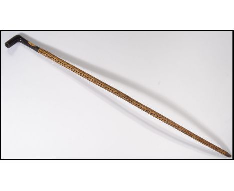 A 19th century Victorian sharks vertebrae walking cane, rosewood handle with inset ivory panel. Measures 82 cm long.