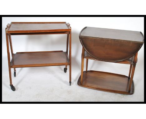 A retro teak wood 20th century two tier buffet trolley by Remploy in the Danish manner together with another buffet trolley b