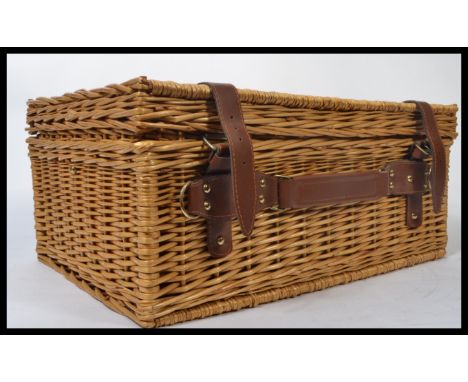 A vintage 20th century retro wicker picnic hamper and contents. The basket fitted with glasses , flask , plates , cutlery etc