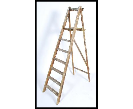 A retro 20th century wooden Industrial ladder having a-frame construction with a series of steps - Ideal for display purposes