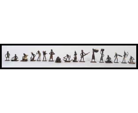 A good collection of Ashanti bronze figurines / gold weights to include hunter with bow , pot carrier , musicians , carrying 