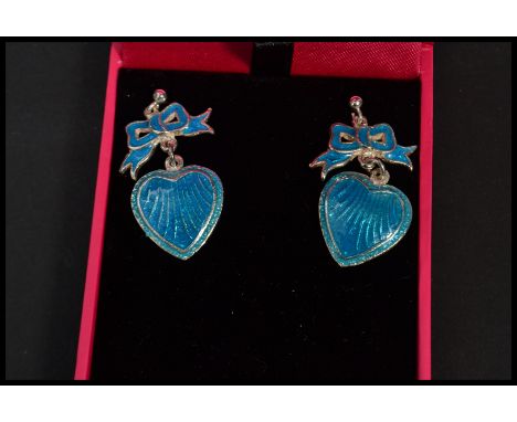 A pair of sterling silver and blue enamel drop earrings in the form of hearts and bows. Complete in box.&nbsp;