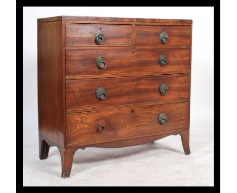 An early 19th century Regency mahogany chest of drawers. The bank of two other three drawers raised on bracket feet with bras