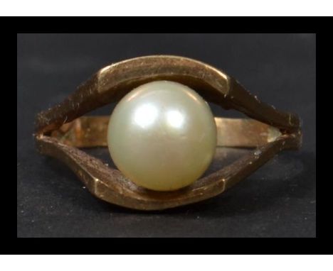 A 9ct gold pearl ring being hallmarked. The central large pearl on suspension setting. Total weight 4.3g complete in the pres