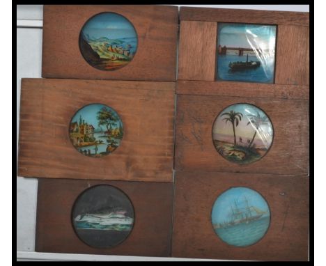 A collection of 19th century Victorian hand coloured glass plat magic lantern slides in wooden frames depicting various scene