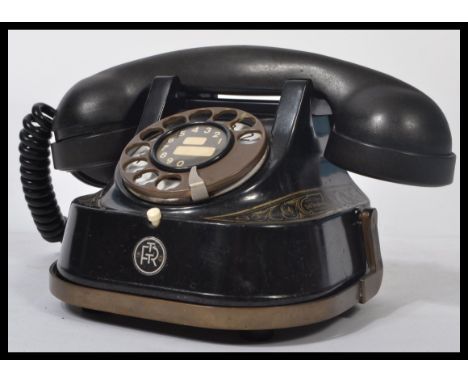 An early 20th century FTR Belgian black telephone handset having good shape with central finger ring dialler and receiver ato