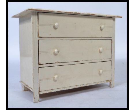 A vintage 20th century Edwardian apprentice pine chest of drawers, three long drawers raised on bracket feet having a later p