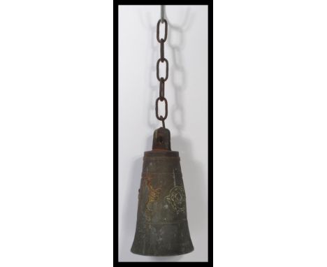 A 19th century Nordic Scandinavian bronze bell inspired by a Viking battle bell, the bell embossed with mythical panels and c