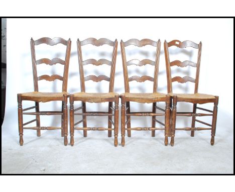 A set of 4 early 20th century French Brittany provincial rattan weave oak ladderback dining chairs. The ladder back rests ove