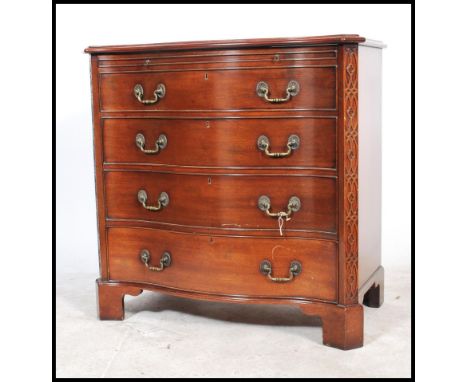 A 20th century bow fronted entertainment cabinet in the form of a Georgian bow front chest of drawers, lift up front over a s