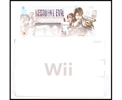 A Nintendo Wii games console, complete within the original box, along with a Resident Evil; The Darkside Chronicles Wii Zappe