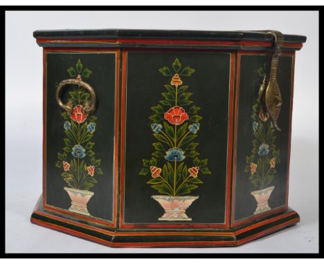 A 20th century decorative folk painted wooden octagonal storage box, fitted hinged lid to the top and each panel painted with