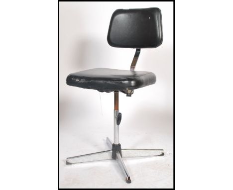 An excellent mid 20th century machinists chair with cast metal base with peripheral stretcher base having black vinyl panel s