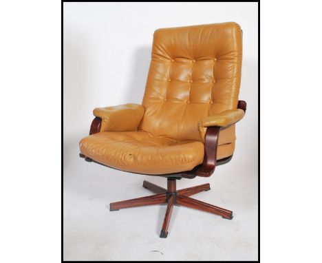 Westnofa - A 20th century retro bentwood swivel lounge armchair having a light tan button backed pad forming both back and se