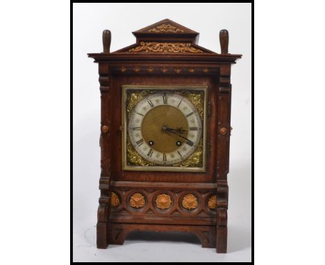 A late 19th / early 20th century German architectural oak cased bracket clock, fitted with a German striking movement stamped